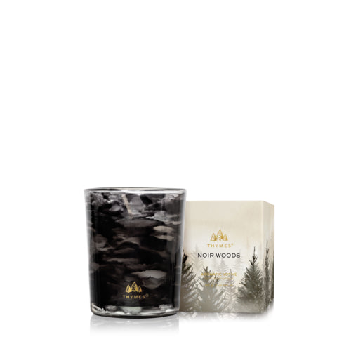 Thymes candle with forest-themed designs on a white background. Available at Be Charmed.  