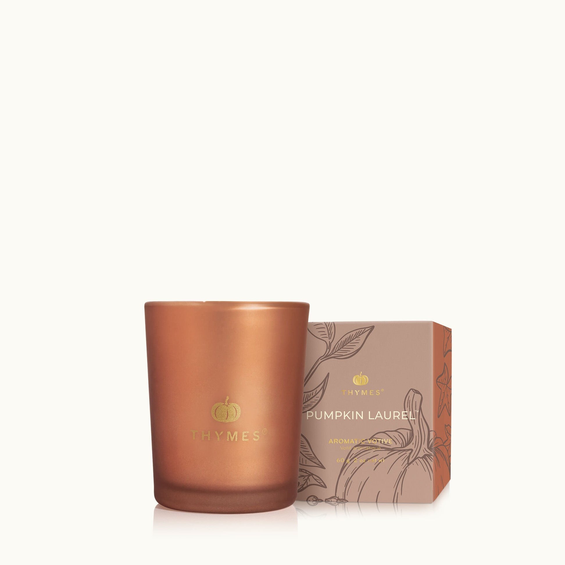 Thymes Pumpkin Laurel 2 oz votive candle in glass cup, warm spice blend of pumpkin, nutmeg, clove & orange peel—Available at Be Charmed.