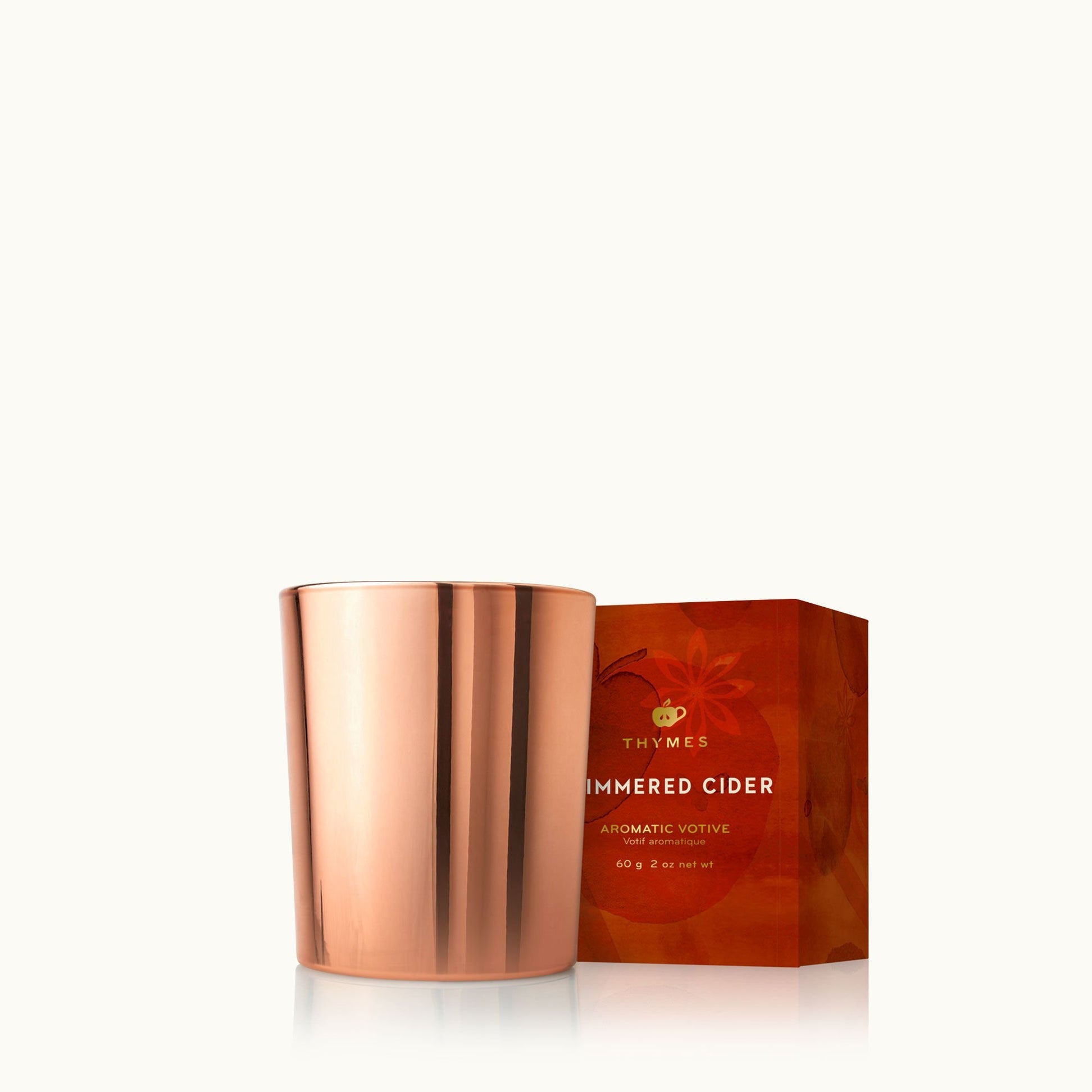 Thymes Simmered Cider 2 oz votive candle in rose-gold tin with apple, clove & cardamom scent—Available at Be Charmed.