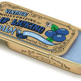 A gold vintage-style lip balm tin with blueberry and grape design, containing blue lip balm. Available at Be Charmed