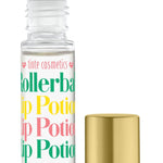 A clear rollerball lip potion bottle labeled 'Birthday Cake' with a colorful label, alongside a gold-colored lid. Available at Be Charmed