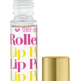 A clear rollerball lip potion bottle with pink and yellow labeling, alongside a gold-colored cap. Available at Be Charmed