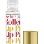 A clear rollerball lip potion bottle with orange, yellow, and pink text displaying 'Tropical Punch Rollerball Lip Potion', alongside a gold-colored cap. Available at Be Charmed