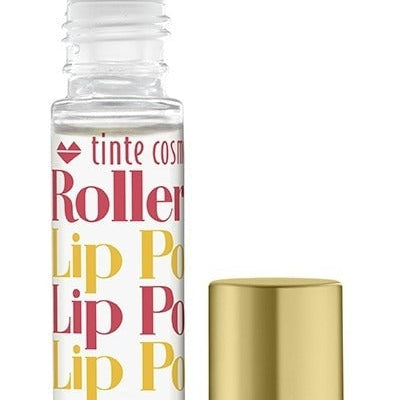 A clear rollerball lip potion bottle with orange, yellow, and pink text displaying 'Tropical Punch Rollerball Lip Potion', alongside a gold-colored cap. Available at Be Charmed