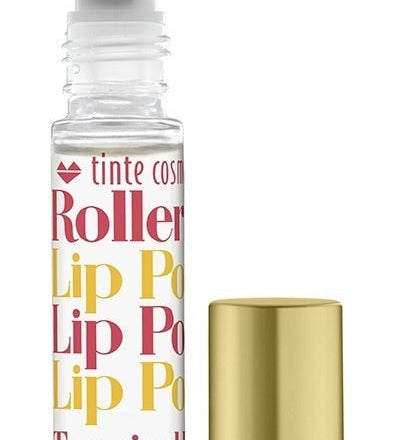 A clear rollerball lip potion bottle with orange, yellow, and pink text displaying 'Tropical Punch Rollerball Lip Potion', alongside a gold-colored cap. Available at Be Charmed
