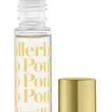 A clear rollerball lip potion bottle with 'TINTE COSMETICS' and 'KISSING POTION VANILLA' printed on it, alongside a gold-colored cap. Available at Be Charmed