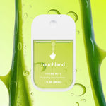 Touchland power mist bottle with aloe vera plant on a green background. Available at Be Charmed