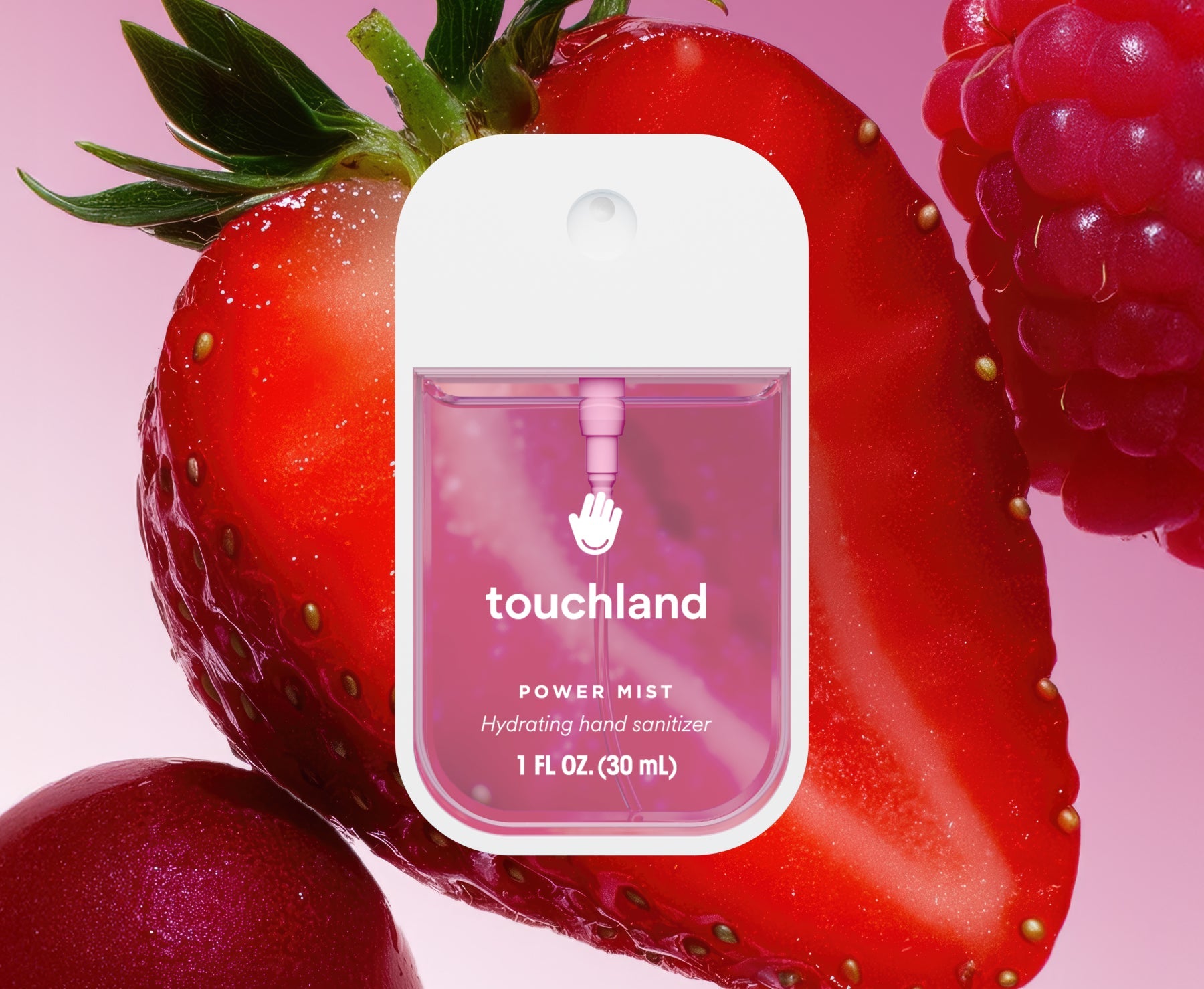 Touchland hand sanitizer packaging on a strawberry with raspberries. Available at Be Charmed