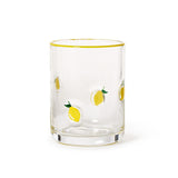 Clear glass double old fashioned with yellow lemon illustrations on a white background. Available at Be Charmed