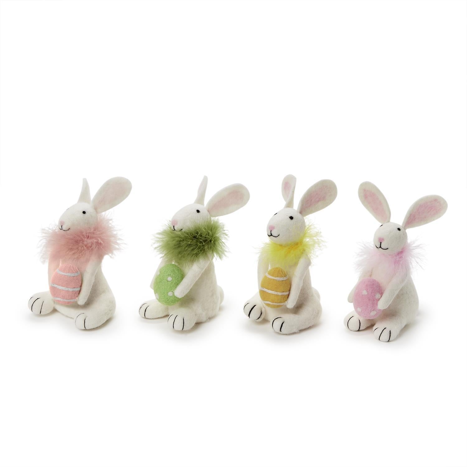 Four plush toy bunnies with colorful fur on a white background. Available at Be Charmed