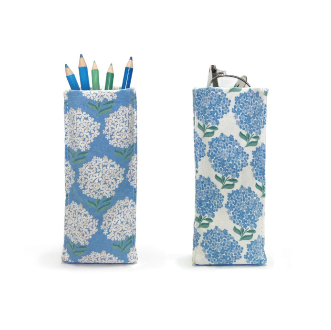 A fabric eyeglass/Accessory holder with a hydrangea flower pattern in blue and white colors. Available at Be Charmed