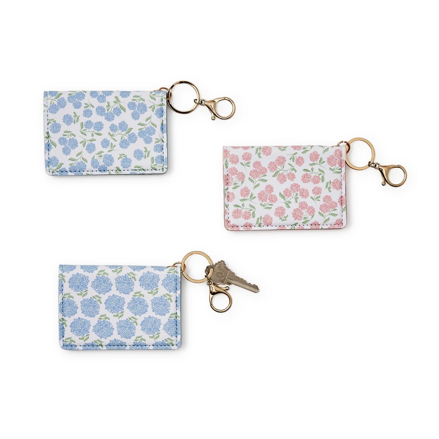 Set of three floral Hydrangea ID Wallet keychains on a white background. Available at Be Charmed  
