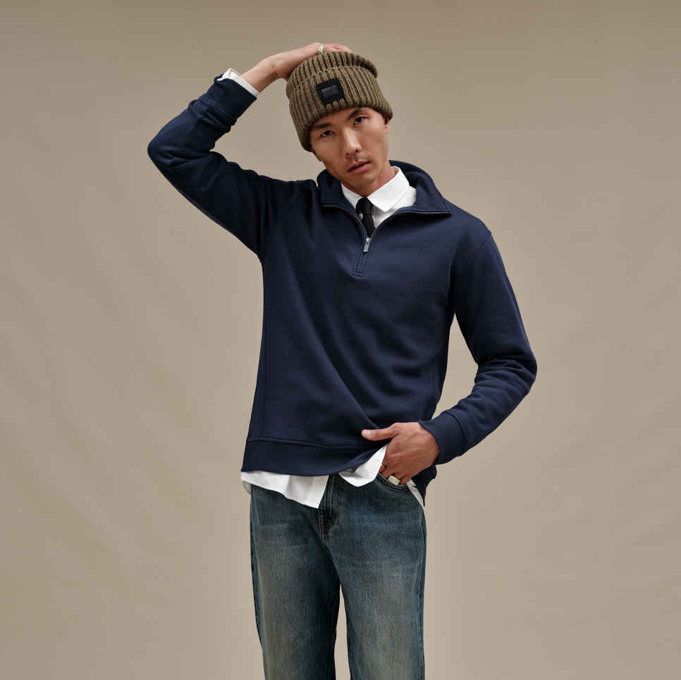 UGG Navy Men's Zeke half-zip pullover sweater in a soft cotton-blend fleece, available at Be Charmed.
