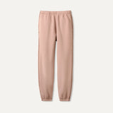 UGG Pink Dawn Patrol sweatpants on a light beige background. Available at Be Charmed. 