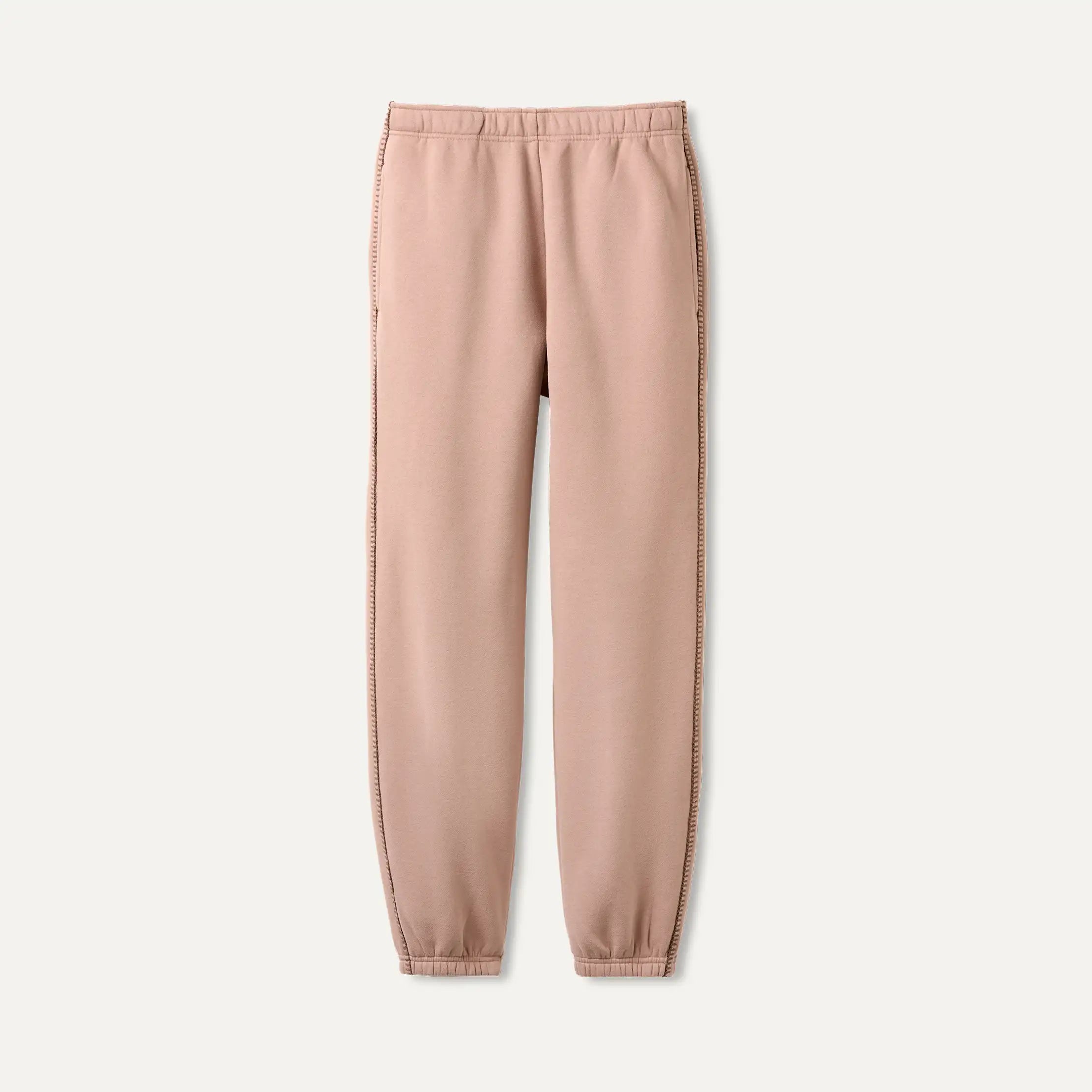 UGG Pink Dawn Patrol sweatpants on a light beige background. Available at Be Charmed. 