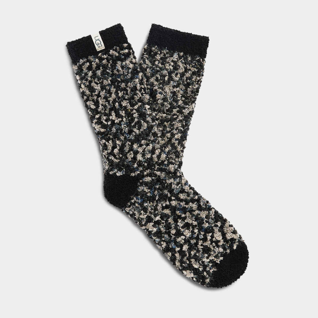 A pair of UGG Women's Cozy Chenille Socks in black, gray, and white colors. Available at Be Charmed. 