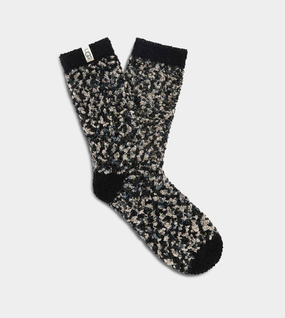 A pair of UGG Women's Cozy Chenille Socks in black, gray, and white colors. Available at Be Charmed. 