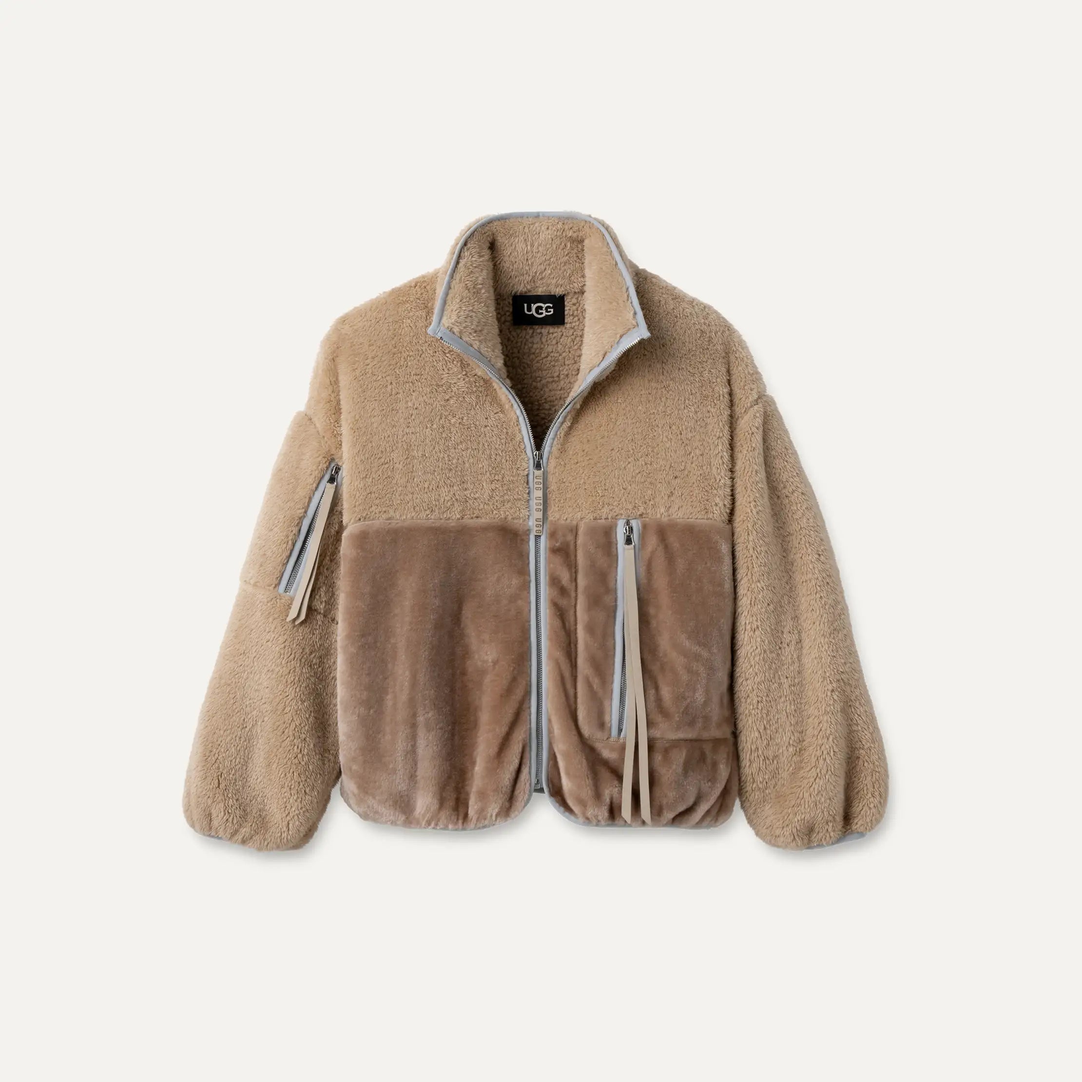 Beige fleece jacket with zippers on a white background. Available at Be Charmed