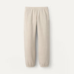 Beige UGG sweatpants on a white background. Available at Be Charmed. 