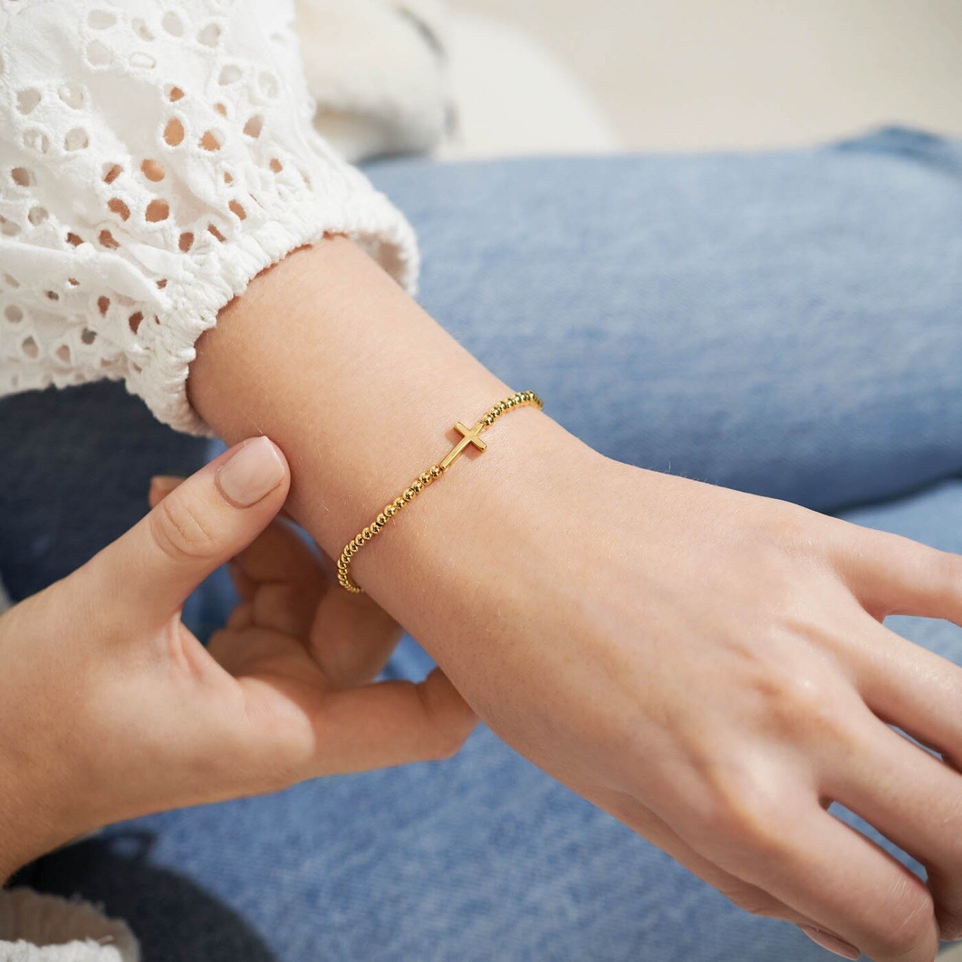 Woman wearing A Littles & Co Gold Faith Bracelet featuring delicate gold finish with faith-inspired design—elegant, meaningful gift from Be Charmed. 