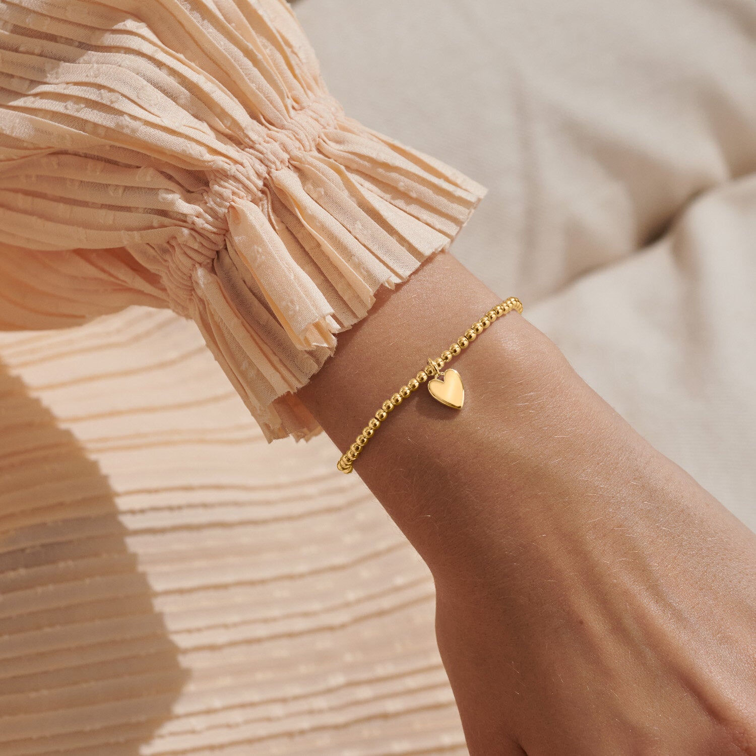Woman Wearing A Littles & Co Marvelous Mama Gold Bracelet featuring delicate gold finish with inspiring “Marvelous Mama” engraving—perfect gift from Be Charmed.
