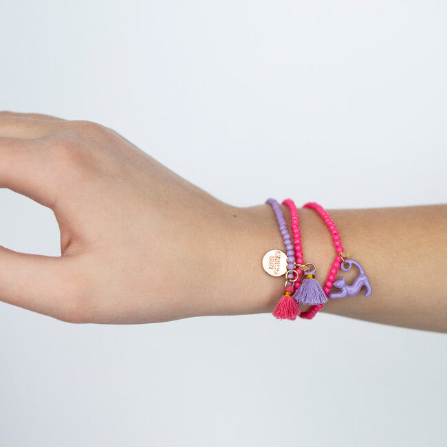 Child wearing  Zoey Cat Bracelet by Calico Sun—a fun adjustable cord bracelet with colorful enamel cat charm, perfect for kids and tween style, available at Be Charmed.