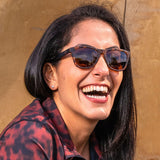 Woman wearing Goodr Bosley's Basset Hound Dreams Sunglasses featuring warm brown frames and polarized lenses, inspired by easygoing charm and perfect for everyday wear, Available at Be Charmed