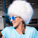 Woman in fur hat Goodr Iced By Yetis Sunglasses featuring frosty white frames and icy blue polarized lenses, built for active comfort and cool adventures, available at Be Charmed