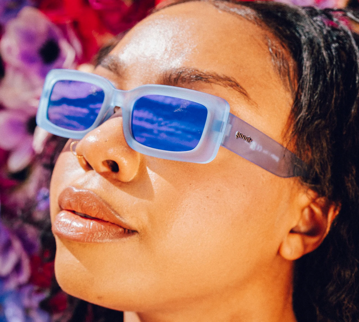 Woman wearing Goodr Lost Highway Desert Mirage sunglasses with polarized lenses and sleek desert-inspired frames—perfect for sports or style, available at Be Charmed.
