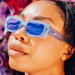 Woman wearing Goodr Lost Highway Desert Mirage sunglasses with polarized lenses and sleek desert-inspired frames—perfect for sports or style, available at Be Charmed.