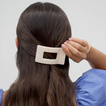 Woman Wearing a Flat Rectangle Hair Clip with bendable teeth, sleek and secure hold—available at Be Charmed.