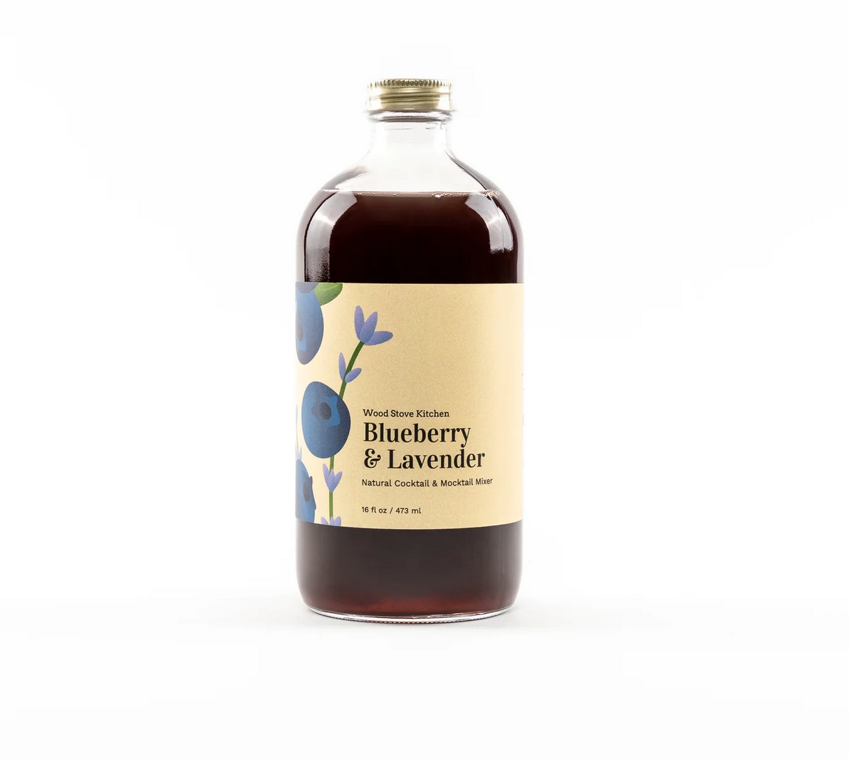 A bottle labeled 'Wood Stove Kitchen Blueberry & Lavender' with a clear liquid visible through the bottle, set against a white background. Available at Be Charmed