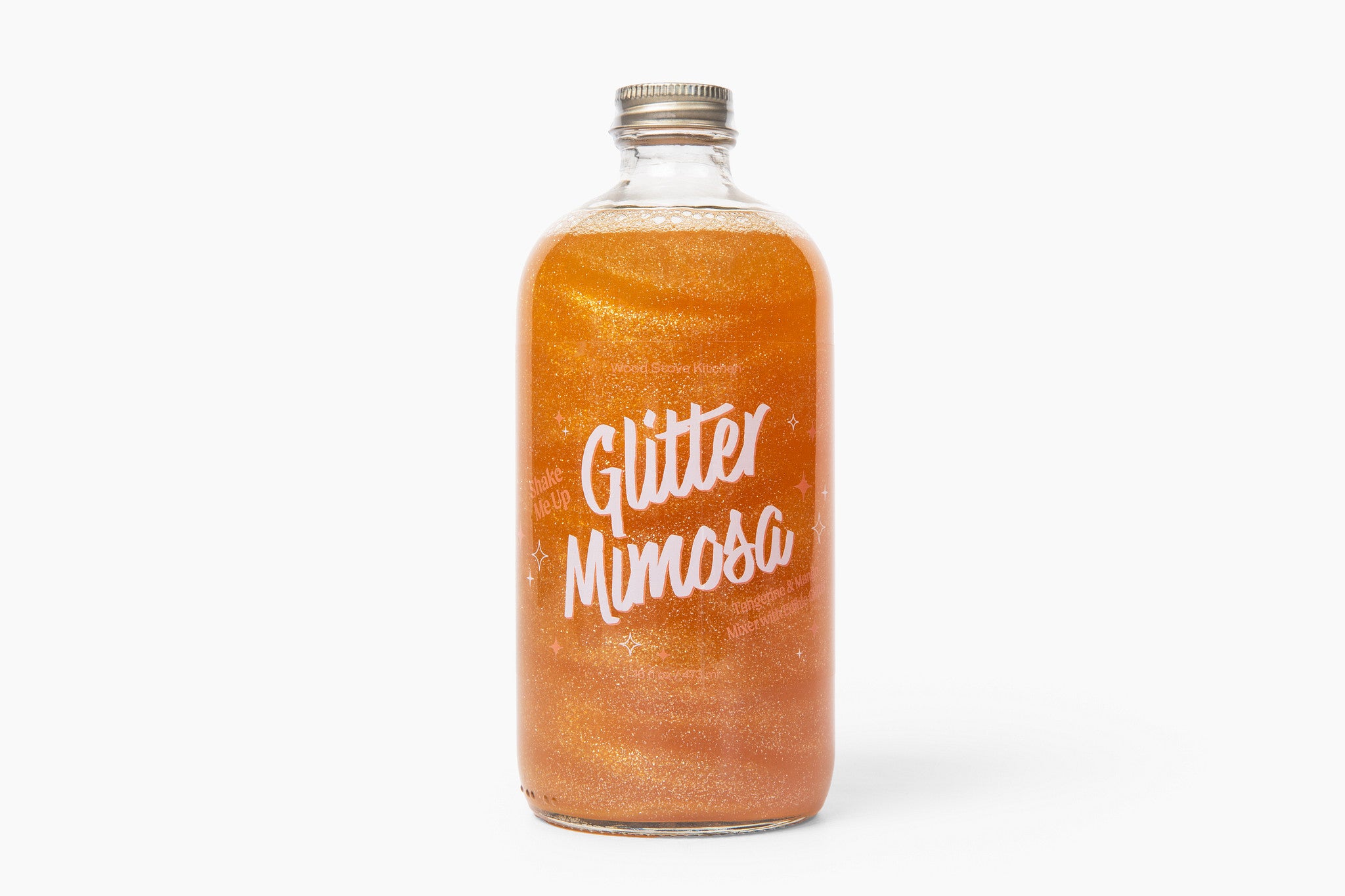 Bottle of 'Wood Stove Kitchen's Glitter Mimosa' on a white background. Available at Be Charmed