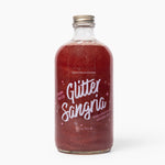 Bottle of Wood Stove Kitchen 'Glitter Sangria' on a white background. Available at Be Charmed