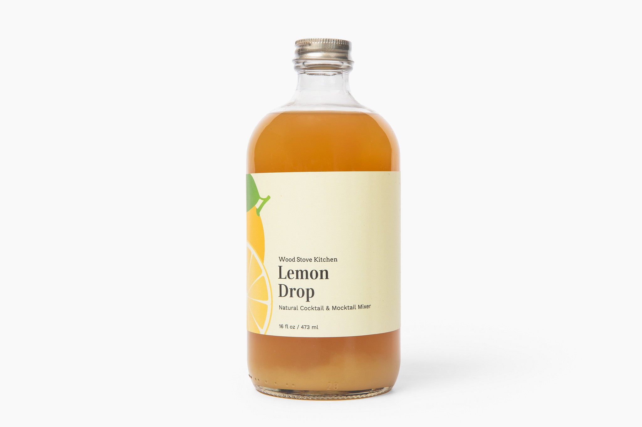 Bottle of Lemon Drop syrup with a label on a white background. Available at Be Charmed