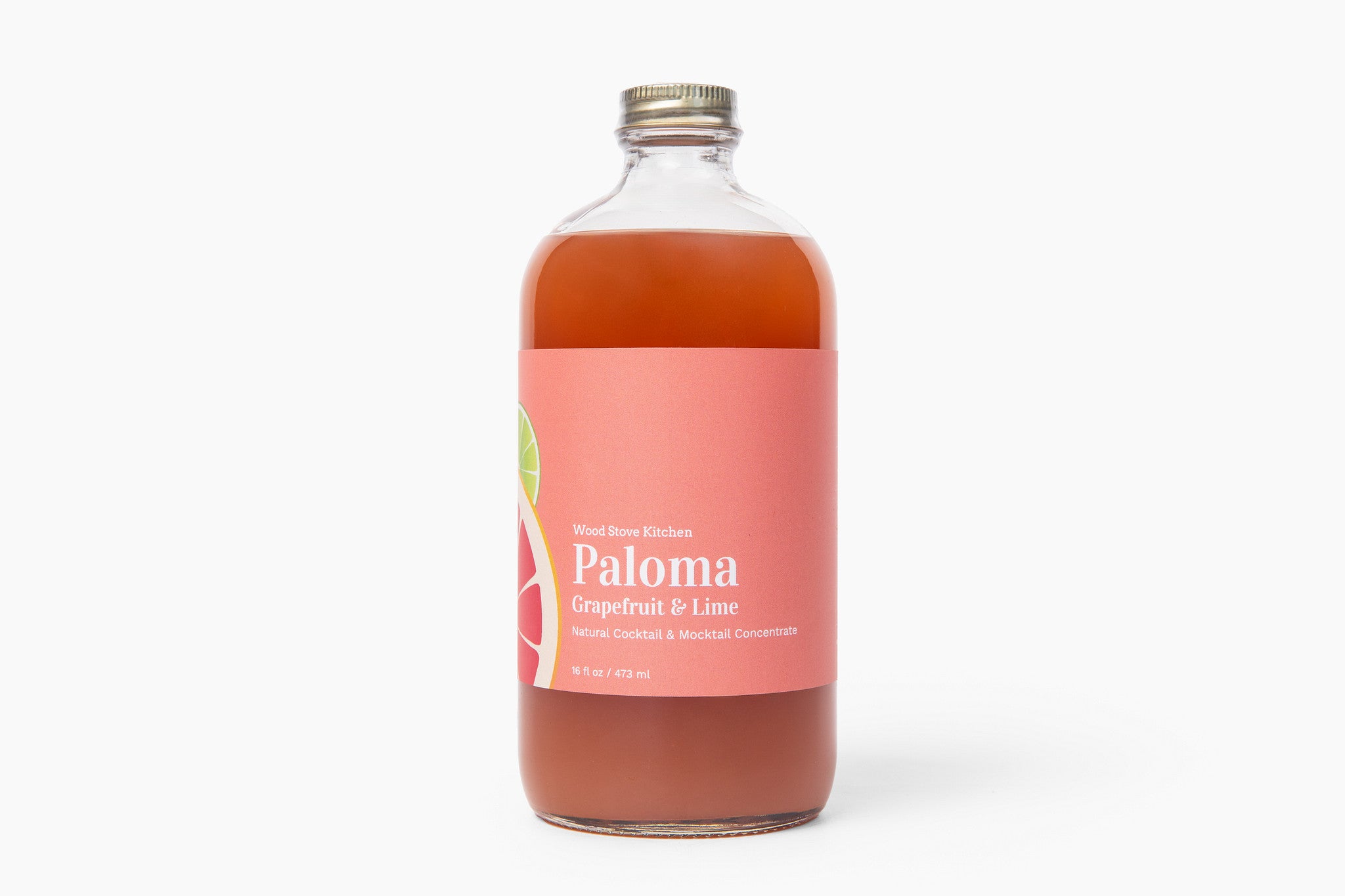 Bottle of Paloma grapefruit and lime cocktail mix on a white background. Available at Be Charmed