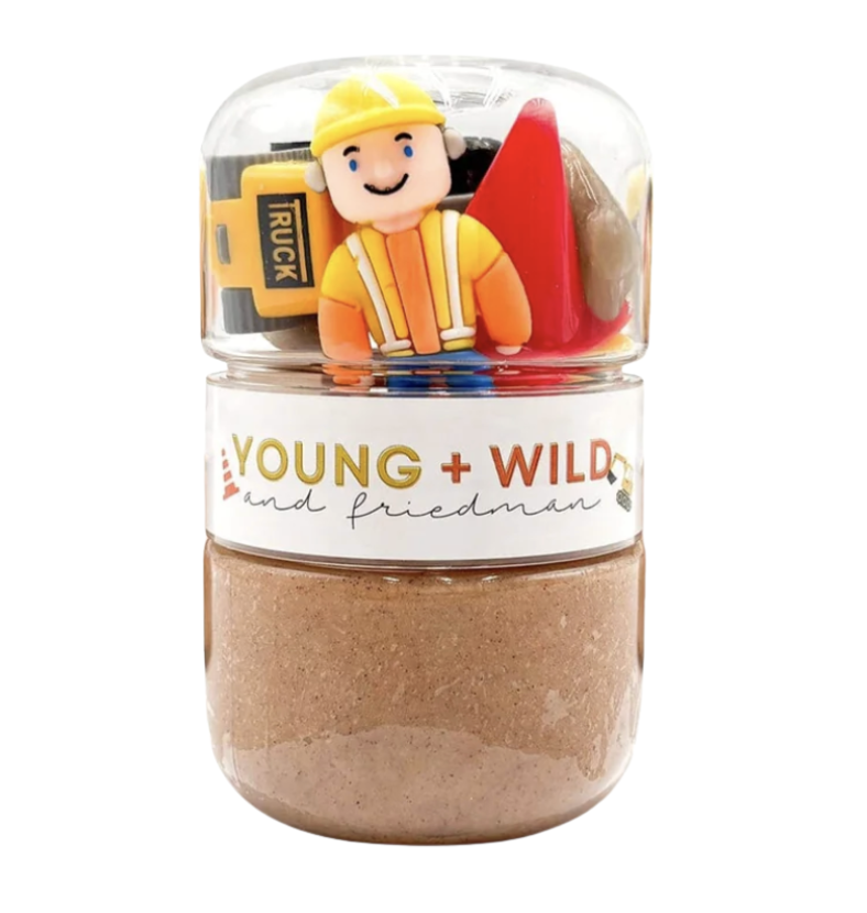 Jar with construction-themed toys and 'Young & Wild' branding on a white background. Available at Be Charmed