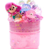 A container of Seashell Shimmer vibrant, non-sticky sensory play slime with themed miniature mix-in trinkets, available at Be Charmed.  