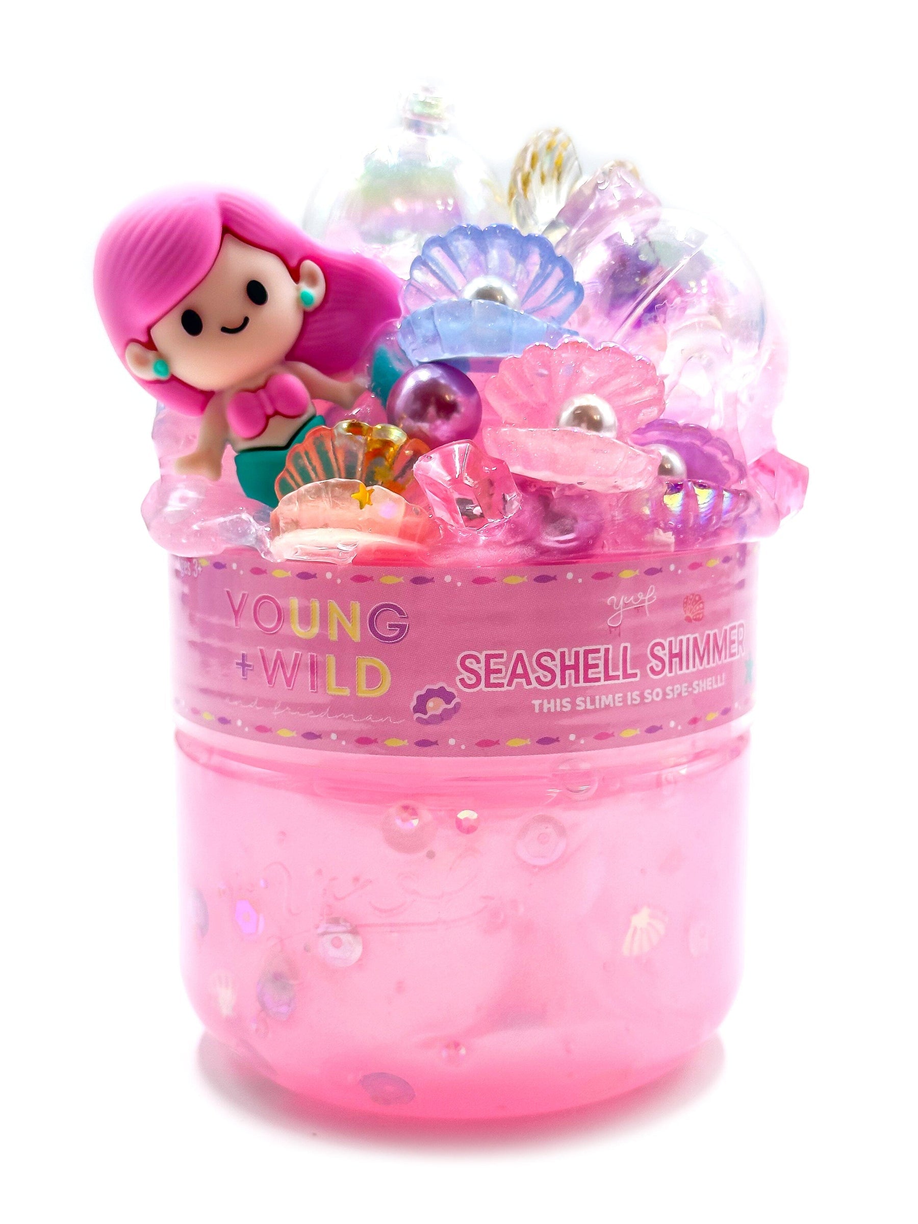 A container of Seashell Shimmer vibrant, non-sticky sensory play slime with themed miniature mix-in trinkets, available at Be Charmed.  