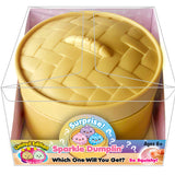 Yellow silicone dumpling mold with a small dumpling inside, in a clear packaging box. Available at Be Charmed