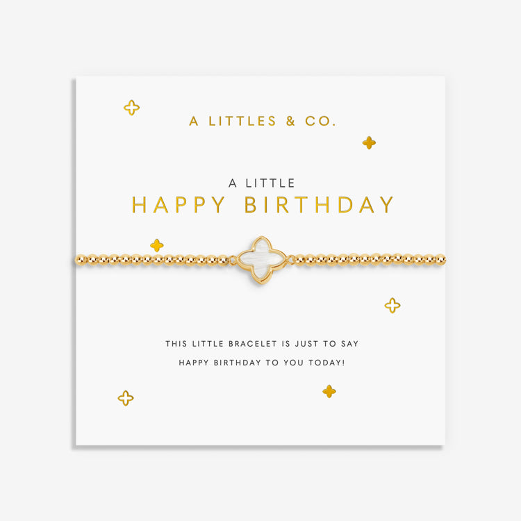 Gold bracelet on a 'Happy Birthday' card with decorative elements. Available at Be Charmed