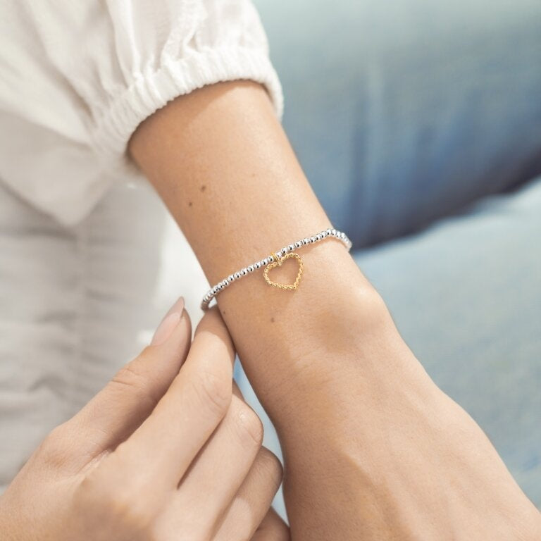 Woman Wearing A Littles & Co Silver Love and Strength Bracelet