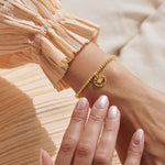 Woman Wearing A Littles & Co Gold Trust In The Magic Of New Beginnings Bracelet