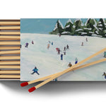 Annapolis Candle Kim Hovell Slope Side Boxed Matches – elegant match box with signature artwork. Available at Be Charmed.