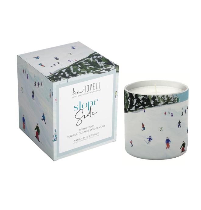 Annapolis Candle Kim Hovell Slope Slide Boxed Candle – crisp winter scent with signature artwork. Available at Be Charmed.