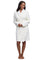 A woman modeling a pearl Barefoot Dreams  textured waffle-knit bathrobe against a white studio background.
