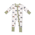 An Angel Dear baby long-sleeve footed sleeper with a white background, olive green trim, and an all-over tractor print in blue, red, and brown. Available at Be Charmed