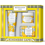 Beekman 1802 Kindness Cafe gift set containing goat milk hand cream, whipped body cream, and honey & orange blossom soap in a yellow and gray patterned box. Available at Be Charmed