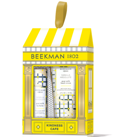Beekman 1802 Kindness Cafe gift set in vanilla absolute containing three hand creams in a yellow and white storefront-themed box with a gold hanging loop. Available at Be Charmed