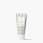 A squeeze tube of Beerman 1853 Fresh Air goat milk hand cream, featuring a white and gray plaid pattern with yellow accents, on a clean white background. Available at Be Charmed